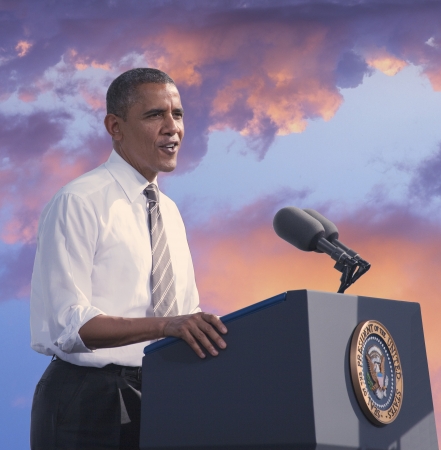 23059147 - president barack obama speaking against a backdrop of a sunset